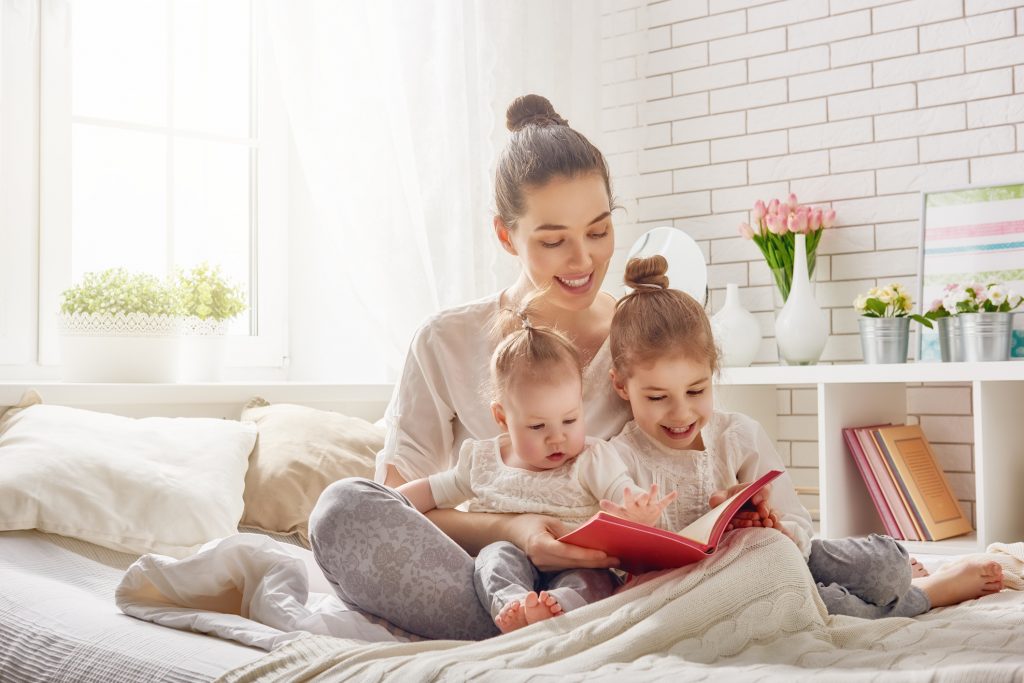 mother reading book to children