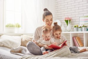 mother reading book to children