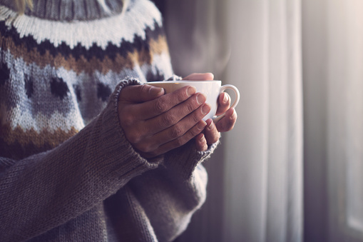 Woman staying warm with furnace heating system