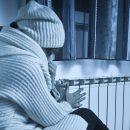 Furnace not heating woman trying to stay warm in cold house.
