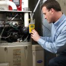 Buy or rent a furnace: an Aire One technician servicing a gas furnace in an Ontario home